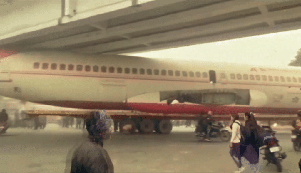 Decommissioned plane stuck under bridge